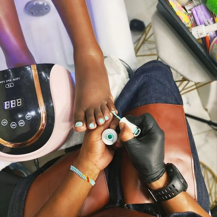 Classic pedicure at SS Braids GH Accra — polish application and foot exfoliation on dark skin at SS BRAIDS GH (ssbraidsgh)